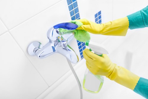 Office cleaner working in a Kensington commercial building with limited access